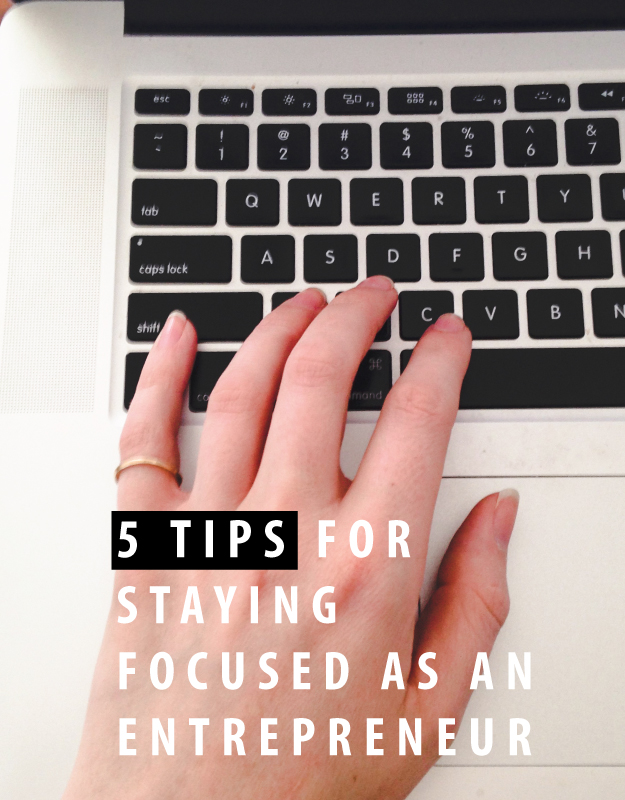 Hand typing "5 tips for staying focused as an entrepreneur"